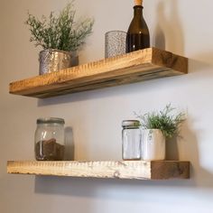 two wooden shelves with jars and plants on them