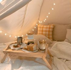 a tray that has food on it and some lights hanging from the ceiling in a tent