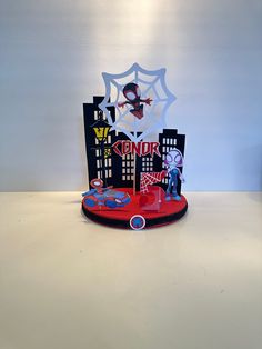 a spiderman birthday cake topper on a table