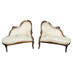 a pair of victorian style chaise lounges with upholstered backrests