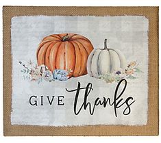 a door mat with two pumpkins and the words give thanks