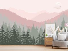 a living room with mountains and trees painted on it's walls, along with a chair