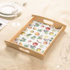 an empty tray on a table with wine glasses