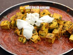 some tofu and sauce in a pan with the words add fresh cream on top