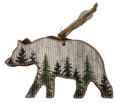 a wooden bear ornament with pine trees on it