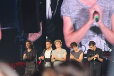 one direction perform on stage at an event