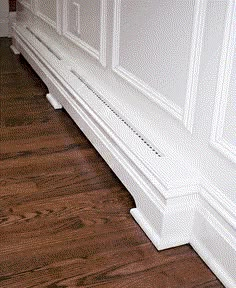 a white bench sitting on top of a hard wood floor