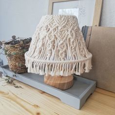 a white lamp sitting on top of a wooden table