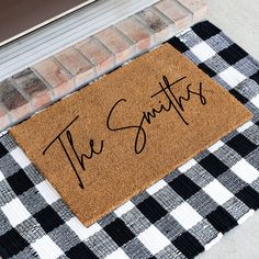 a welcome mat with the words the smiths on it sitting next to a door