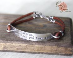 a leather bracelet with an engraved message on it