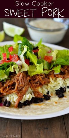 slow cooker sweet pork burritos with black beans and lettuce on top