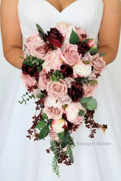 a bridal holding a bouquet of pink and red flowers