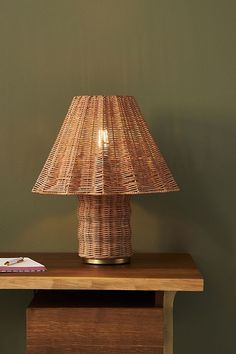 a lamp that is sitting on top of a table next to a bookshelf