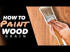 a hand holding a paint brush over a wooden surface with the words how to paint wood grain