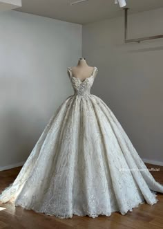 a white wedding dress on display in a room