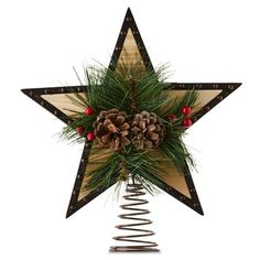 a wooden star decoration with pine cones and berries