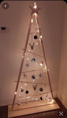 a wooden christmas tree with lights on it