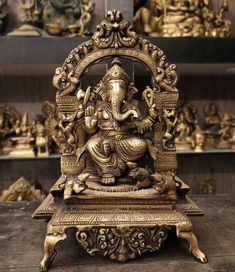 a statue of an elephant sitting on top of a wooden table