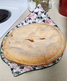 a pie sitting on top of a table next to a stove