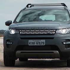 a grey land rover is parked on the beach