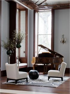 a living room filled with furniture and a grand piano