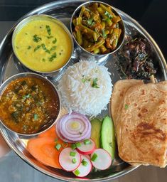 a metal plate topped with different types of food