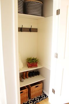 a white closet with baskets and shoes in it