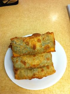 two pieces of fried food on a white plate