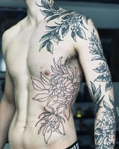 a shirtless man with flowers on his chest