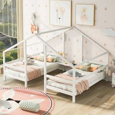 two beds in a room with pink walls and flooring, one has a white bed frame