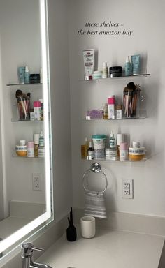 a bathroom sink sitting under a mirror next to a shelf filled with cosmetics and personal care items