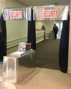 an entrance to a security office with people standing around