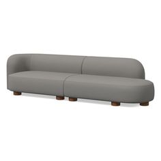 a gray couch with two wooden legs sitting on top of the back side of it