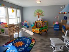 a child's playroom with toys and furniture