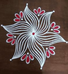 a white and red flower design on a brown surface