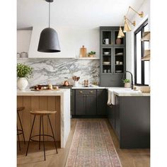 a kitchen with gray cabinets and an area rug