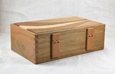 a wooden box sitting on top of a white surface