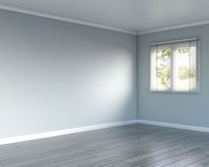 an empty room with white walls and wooden floors