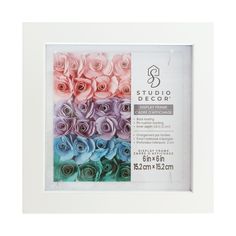 a white frame with multicolored paper roses in it