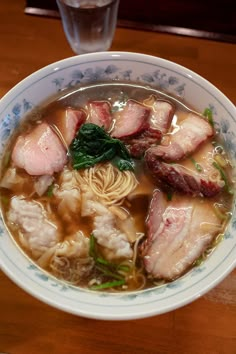 a bowl of soup with meat and noodles