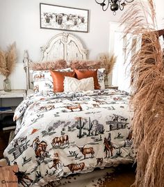 a bedroom with a bed covered in a white comforter next to a tall grass plant