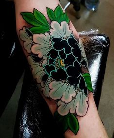 a person with a flower tattoo on their arm