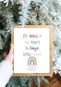 someone holding up a card that says it takes a big heart to shape little minds