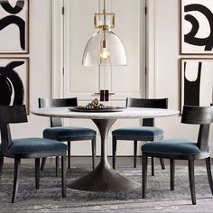 a dining room table with four chairs around it