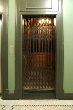 an open door to a room with green walls