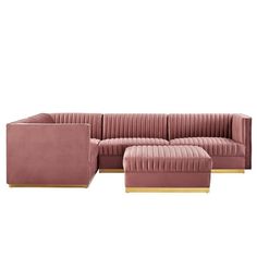 a pink velvet sectional sofa with gold legs and footstools on an isolated white background