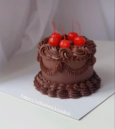 a chocolate cake with cherries on top