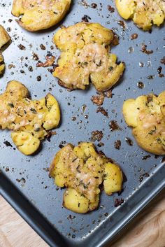 crispy parmesan smashed potatoes on a baking sheet with text overlay that reads crispy parmesan smashed potatoes