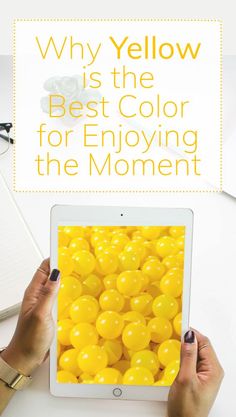 hands holding an ipad with yellow balls on it and the words enjoy the moment, enjoy your life