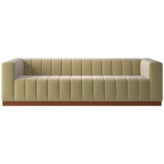 a beige couch sitting on top of a wooden table